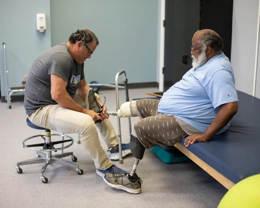 A Bremer prosthetist working with a patient at the Saginaw clinic